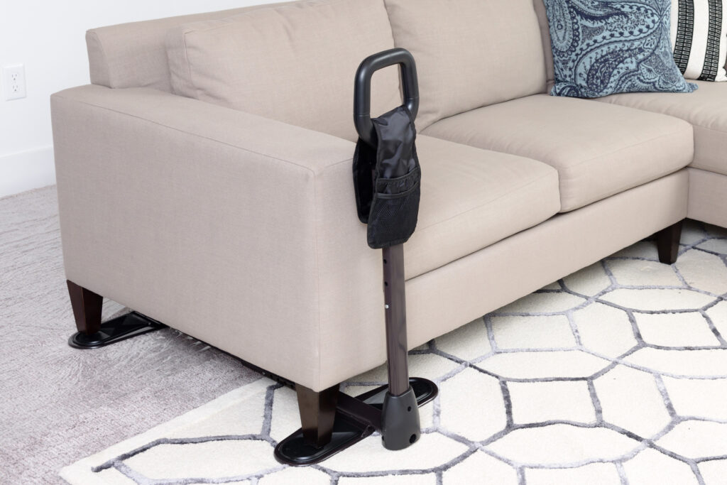 A black CouchCane by Stander in front of a cream couch.