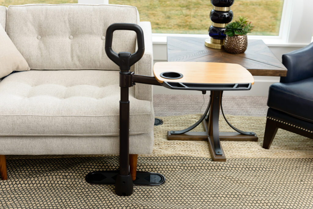 A Stander Assist-A-Tray in front of a cream couch. 