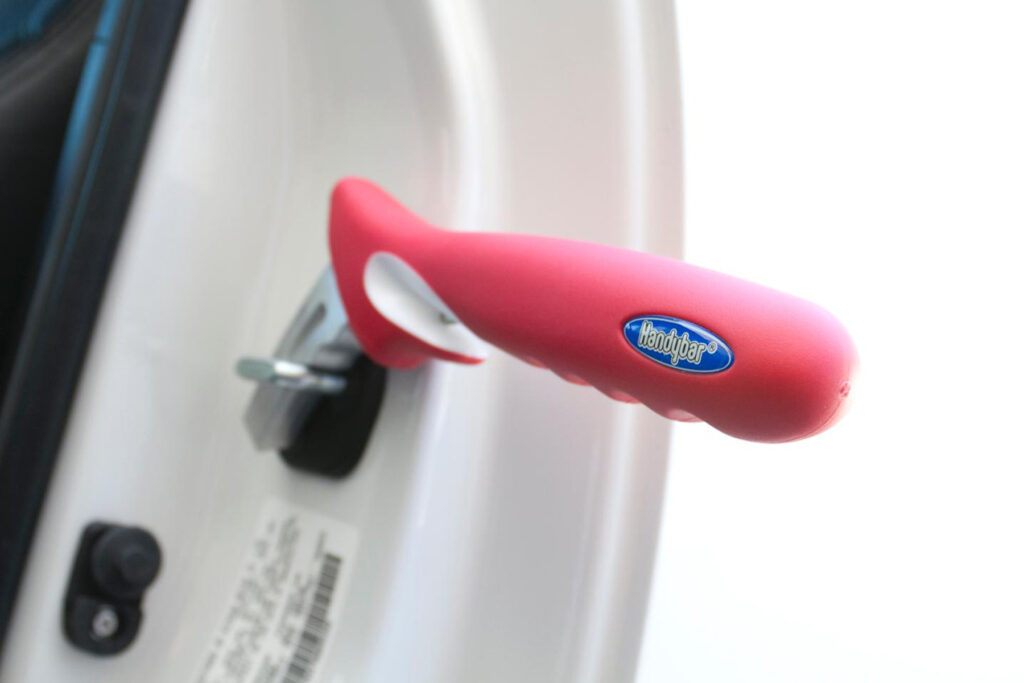 A red HandyBar by Stander on a white car.