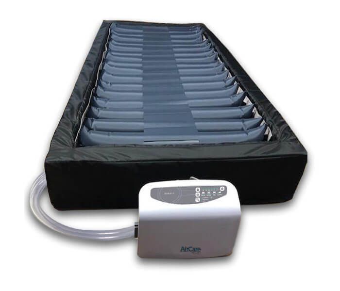 A black and blue Domus Edge Alternating Pressure Therapy System with a  pump.