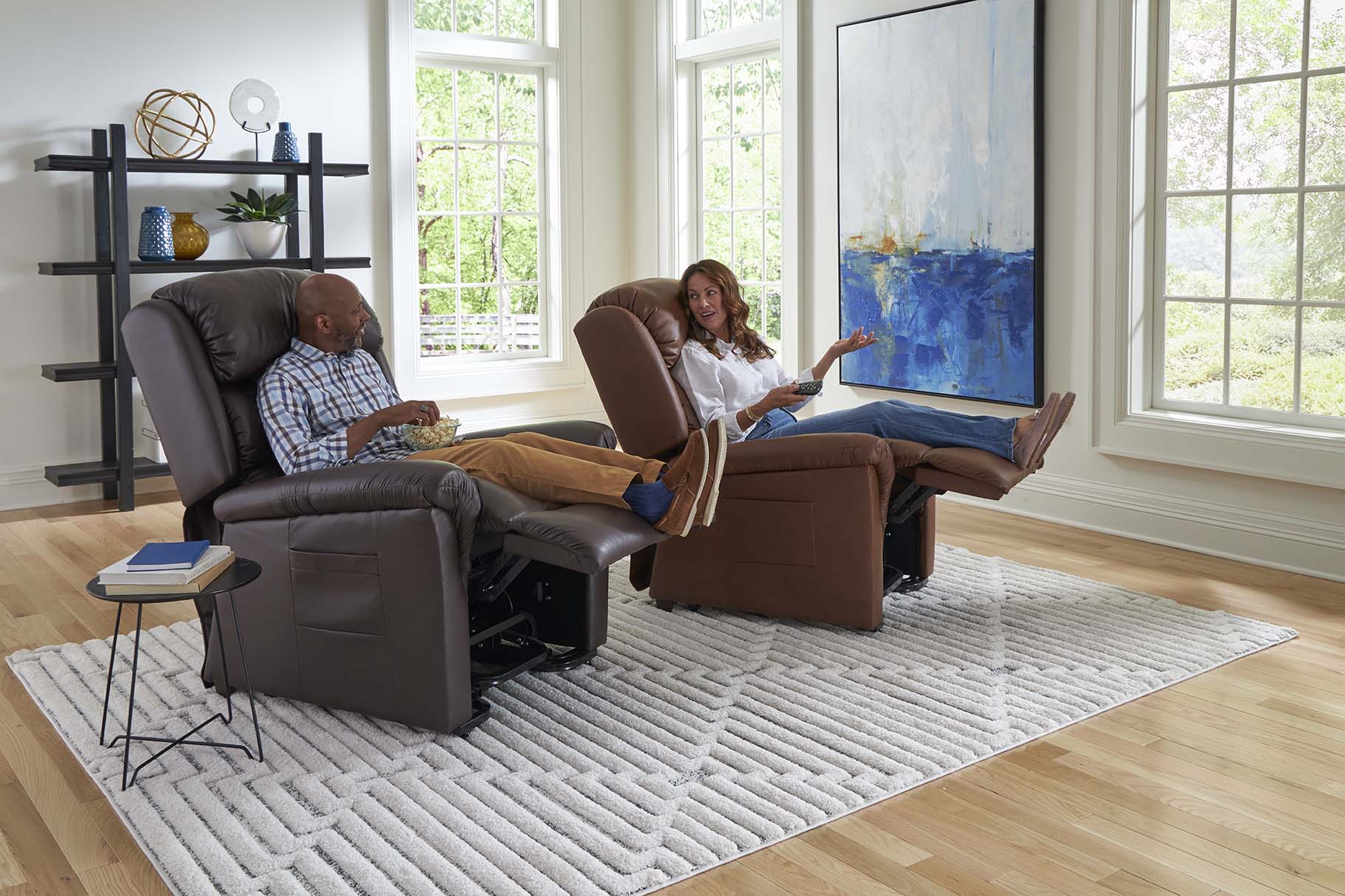 Man on left and woman on right both reclined in power lift recliners